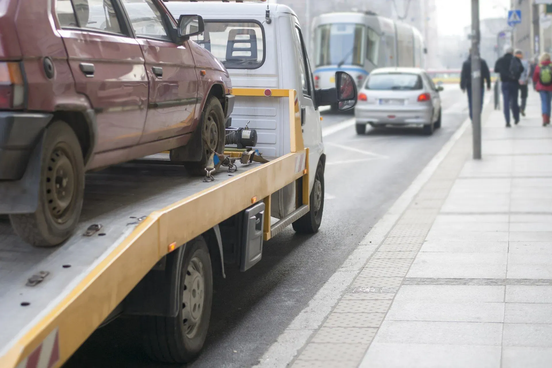 Tow truck operating in city traffic during roadside assistance
